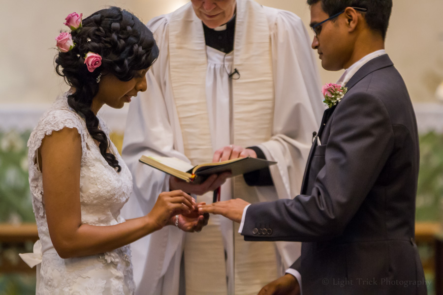 groom and bride exchanging rings in a church